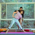 Professional yoga instructor smiling warmly.